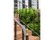Close-up of brick steps with a black railing, featuring a decorative gold end post at 1904 Victoria Rd, Raleigh, NC 27608