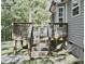 Elevated wooden deck with stairs, overlooking a lush green backyard for outdoor enjoyment at 1980 Ferbow St, Creedmoor, NC 27522