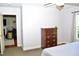 View from bedroom into adjacent living area with fireplace, plus a chest of drawers at 1980 Ferbow St, Creedmoor, NC 27522