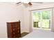 The bedroom features a chest of drawers, a ceiling fan, and a view from the window at 1980 Ferbow St, Creedmoor, NC 27522
