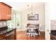 Bright dining area featuring a round table with wooden floors and backyard view at 1980 Ferbow St, Creedmoor, NC 27522