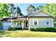 Charming single-story home with a well-manicured lawn, cozy front porch and attached garage at 1980 Ferbow St, Creedmoor, NC 27522