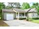 A well maintained home with an attached garage, an expansive driveway and verdant landscaping at 1980 Ferbow St, Creedmoor, NC 27522