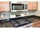 The kitchen features stainless steel appliances, granite countertops, and mosaic tile backsplash at 1980 Ferbow St, Creedmoor, NC 27522