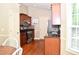 Modern kitchen with stainless steel appliances, granite countertops, ample cabinetry, and a window view at 1980 Ferbow St, Creedmoor, NC 27522