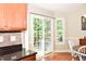 Bright kitchen area with sliding door to back deck, stainless appliances and stone backsplash at 1980 Ferbow St, Creedmoor, NC 27522