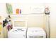 Bright laundry room featuring a modern washer and dryer with convenient shelving at 1980 Ferbow St, Creedmoor, NC 27522