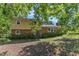 Two-story home showcasing a brick and siding exterior with mature shade trees at 2010 Summerdale Dr, Raleigh, NC 27604
