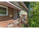 Side entrance view, complete with brick accents, siding, and lush foliage at 2010 Summerdale Dr, Raleigh, NC 27604