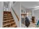 Interior shot of a home's staircase, showing bare wood stairs and white banister at 2010 Summerdale Dr, Raleigh, NC 27604