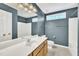 Well-lit bathroom with double sink vanity, large mirror, and shower-tub combo for modern convenience at 2037 Summer Shire Way, Raleigh, NC 27604