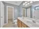 Bathroom featuring a double vanity, blue walls, and a walk-in closet at 2037 Summer Shire Way, Raleigh, NC 27604