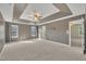 Spacious bedroom featuring tray ceilings, natural light, and ensuite bath at 2037 Summer Shire Way, Raleigh, NC 27604