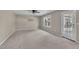 Bonus room with neutral carpet, neutral paint, a window and a door leading to the outside at 2037 Summer Shire Way, Raleigh, NC 27604