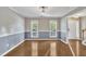Dining room features hardwood floors, neutral paint, and two large windows at 2037 Summer Shire Way, Raleigh, NC 27604