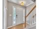 Bright entryway features hardwood floors, stairs, white door and side windows providing natural light at 2037 Summer Shire Way, Raleigh, NC 27604
