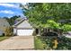 View of the exterior of the home featuring attractive landscaping and a tree in the front yard at 2037 Summer Shire Way, Raleigh, NC 27604