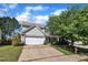 Charming two-story home with a two car garage, a well manicured lawn, and mature landscaping at 2037 Summer Shire Way, Raleigh, NC 27604