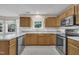 Bright kitchen featuring stainless steel appliances, natural wood cabinets, ample countertop space, and a stylish faucet at 2037 Summer Shire Way, Raleigh, NC 27604