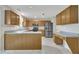 Well-equipped kitchen featuring stainless steel appliances, ample wood cabinetry, and a convenient breakfast bar peninsula at 2037 Summer Shire Way, Raleigh, NC 27604