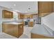 Updated kitchen with stainless steel appliances, gray countertops, natural wood cabinets, and light, airy paint at 2037 Summer Shire Way, Raleigh, NC 27604