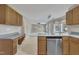 Open kitchen view into the living room featuring stainless steel appliances and countertops at 2037 Summer Shire Way, Raleigh, NC 27604