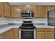 Well-lit kitchen featuring stainless steel appliances and ample cabinet space at 2037 Summer Shire Way, Raleigh, NC 27604