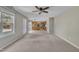 Cozy living room with neutral walls, carpet flooring, and a ceiling fan; kitchen is visible in the background at 2037 Summer Shire Way, Raleigh, NC 27604