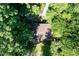 Aerial view of a home nestled within a dense forest offering privacy and natural beauty at 205 Bruton Dr, Chapel Hill, NC 27516