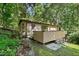 Exterior of the house with a deck and surrounding foliage at 205 Bruton Dr, Chapel Hill, NC 27516