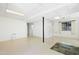 Finished basement with tiled floors, built-in shelving, and windows at 205 Bruton Dr, Chapel Hill, NC 27516
