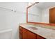 Bathroom featuring marble countertop, wood cabinetry, and decorative mirror at 205 Bruton Dr, Chapel Hill, NC 27516