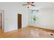 Bedroom features hardwood floors, a ceiling fan, and a bright window at 205 Bruton Dr, Chapel Hill, NC 27516