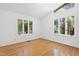 Bedroom featuring large windows and hardwood floors, offering plenty of natural light at 205 Bruton Dr, Chapel Hill, NC 27516