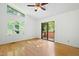 Bedroom with hardwood floors, a ceiling fan, and a sliding door to balcony at 205 Bruton Dr, Chapel Hill, NC 27516