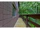 Side deck with wooden planks and wooden railing provides a relaxing outdoor space at 205 Bruton Dr, Chapel Hill, NC 27516