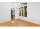 Bright dining area with hardwood floors, modern lighting, and view into updated kitchen at 205 Bruton Dr, Chapel Hill, NC 27516