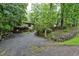 Long driveway surrounded by lush greenery leads to the charming home's exterior at 205 Bruton Dr, Chapel Hill, NC 27516