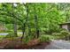 Home surrounded by lush greenery with a walkway leading to the property at 205 Bruton Dr, Chapel Hill, NC 27516