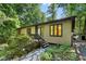 Charming home exterior with stone pathway, lush greenery and natural light throughout at 205 Bruton Dr, Chapel Hill, NC 27516