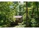 Secluded home surrounded by lush trees and greenery offering maximum privacy at 205 Bruton Dr, Chapel Hill, NC 27516