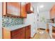 Updated kitchen with granite countertops, wood cabinets, and stainless steel appliances at 205 Bruton Dr, Chapel Hill, NC 27516
