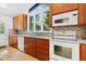Bright and updated kitchen with tile backsplash, stainless steel appliances, and hardwood floors at 205 Bruton Dr, Chapel Hill, NC 27516