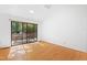 Bright living room featuring hardwood floors and a sliding glass door leading to a deck at 205 Bruton Dr, Chapel Hill, NC 27516
