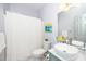 Bathroom with white marble floors, vessel sink vanity and a bathtub with shower at 206 Lilliput Ln, Wake Forest, NC 27587