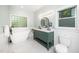 Stylish bathroom with a soaking tub, double vanity, and modern fixtures at 206 Lilliput Ln, Wake Forest, NC 27587
