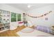 bedroom featuring a rainbow rug, fun decorations and a window with natural light at 206 Lilliput Ln, Wake Forest, NC 27587