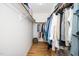 Walk-in closet featuring wood floors, ample hanging space and a built-in shelf at 206 Lilliput Ln, Wake Forest, NC 27587