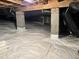 View of the crawlspace showing a vapor barrier and structural supports at 206 Lilliput Ln, Wake Forest, NC 27587