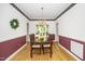 Formal dining room with chair rail, chandelier, and hardwood floors at 206 Lilliput Ln, Wake Forest, NC 27587